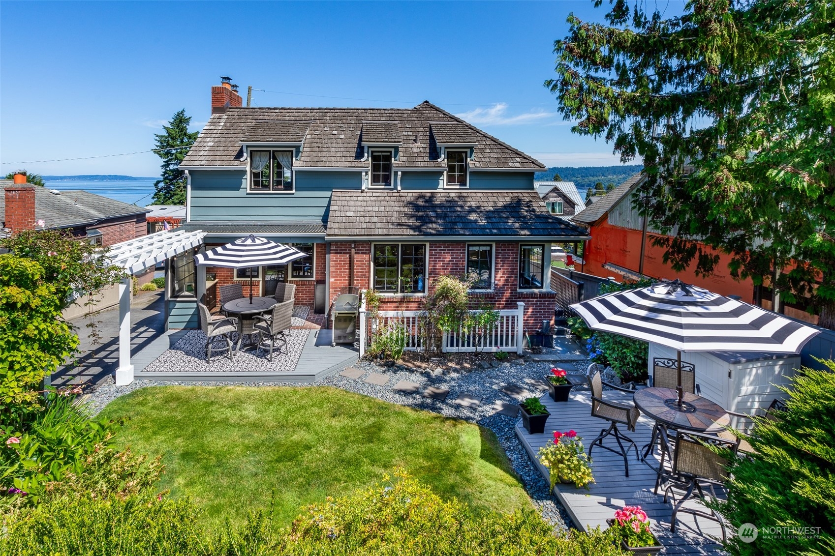 a view of a patio with chair and tables back yard of the house