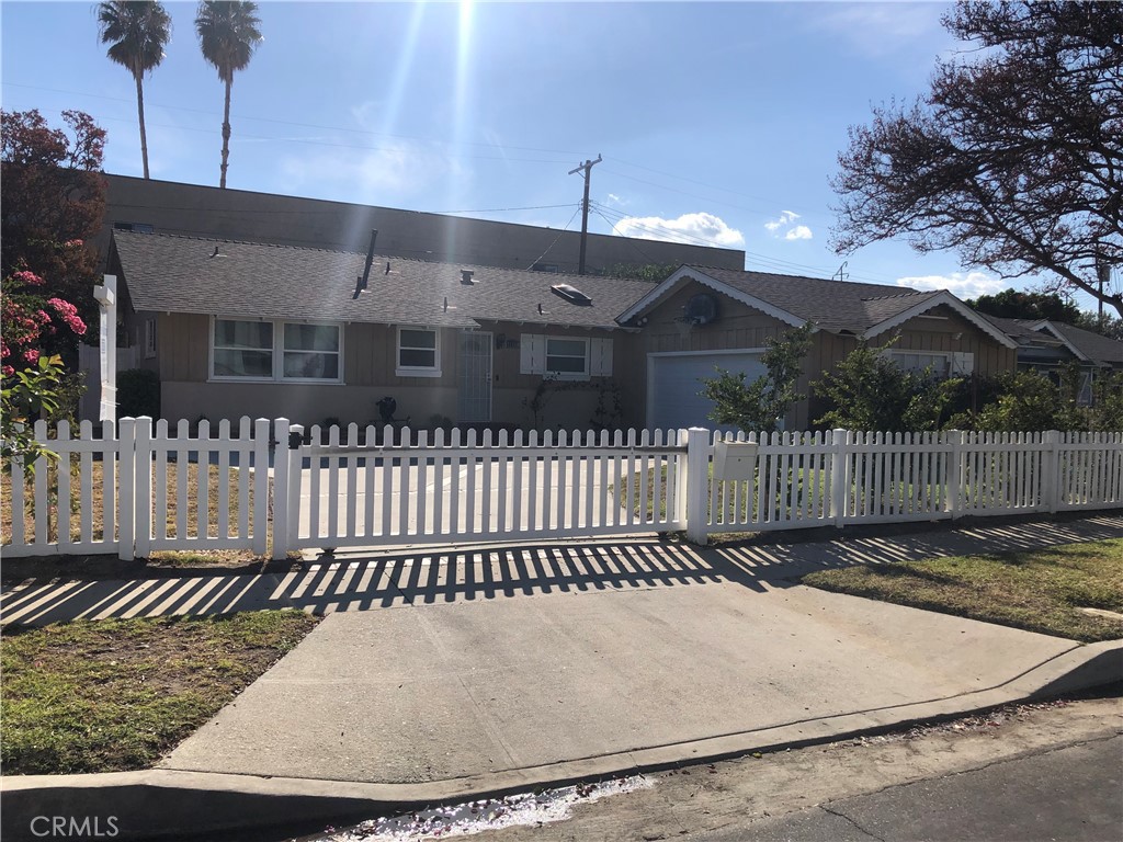 a view of a brick house with a small yard