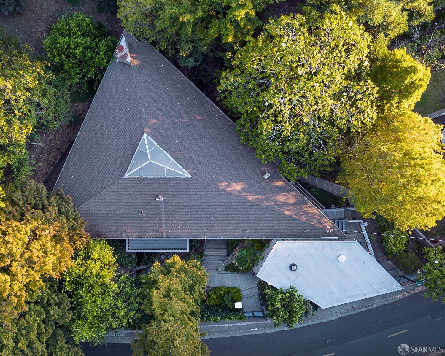 an aerial view of a house with a yard and garden