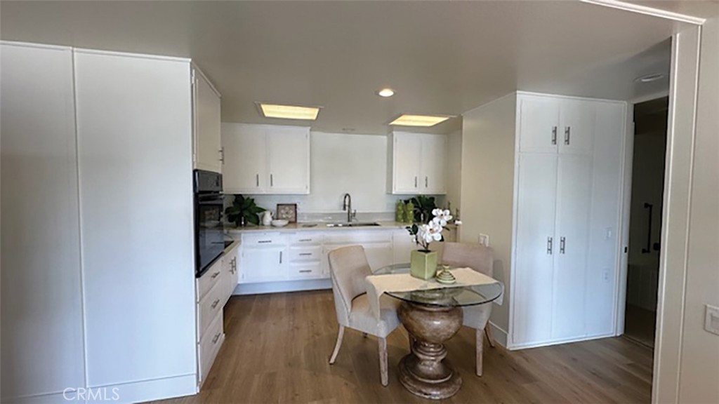 a kitchen with a dining table chairs and refrigerator