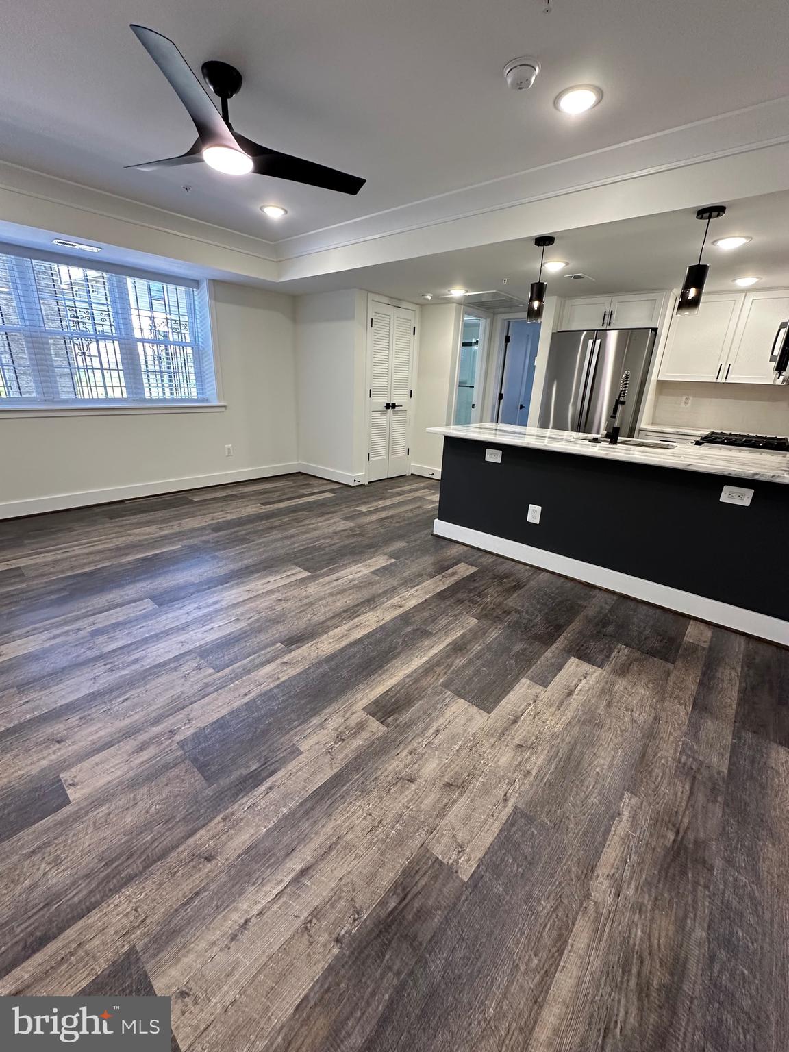 a view of kitchen with cabinets and wooden floor