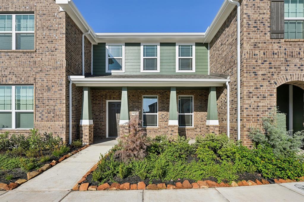 front view of a brick house with a large window