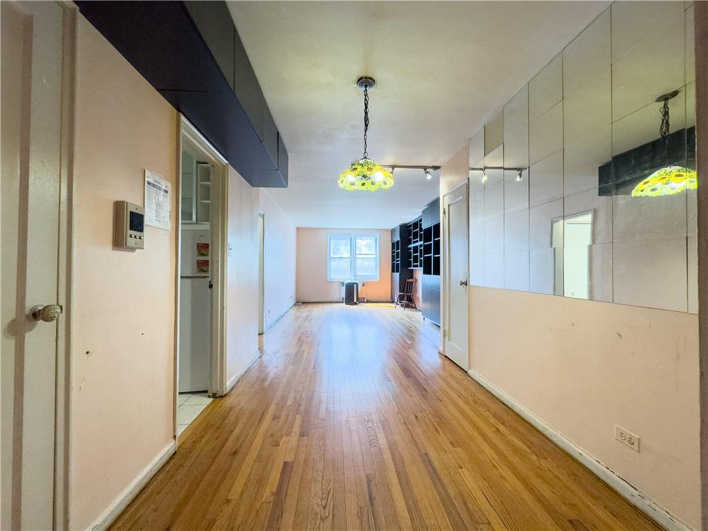 The view from the entrance, looking through "open plan" dining area to living room. Extensive shelving included or may be easily removed.