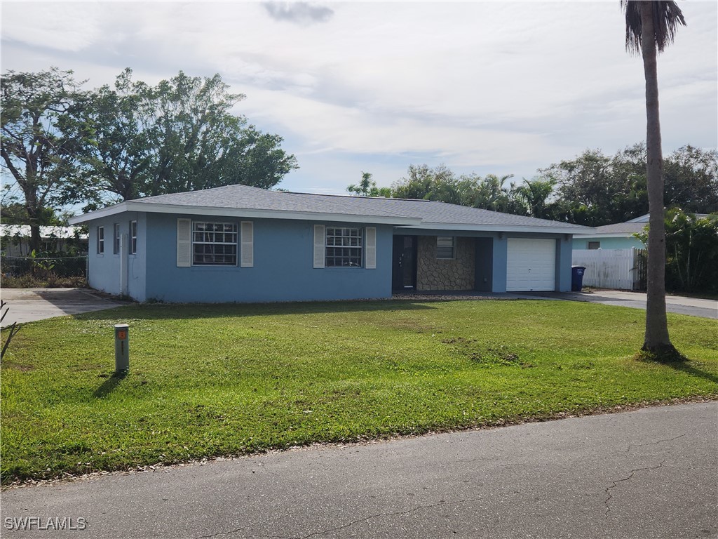 a front view of a house with a garden and yard