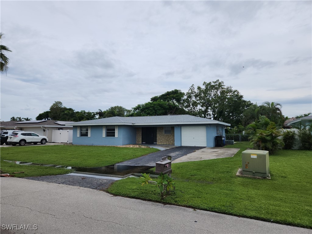 a front view of house with yard and green space