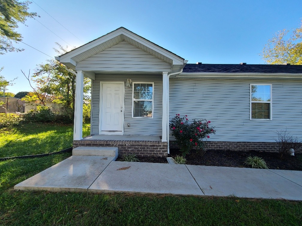 a front view of a house with a garden