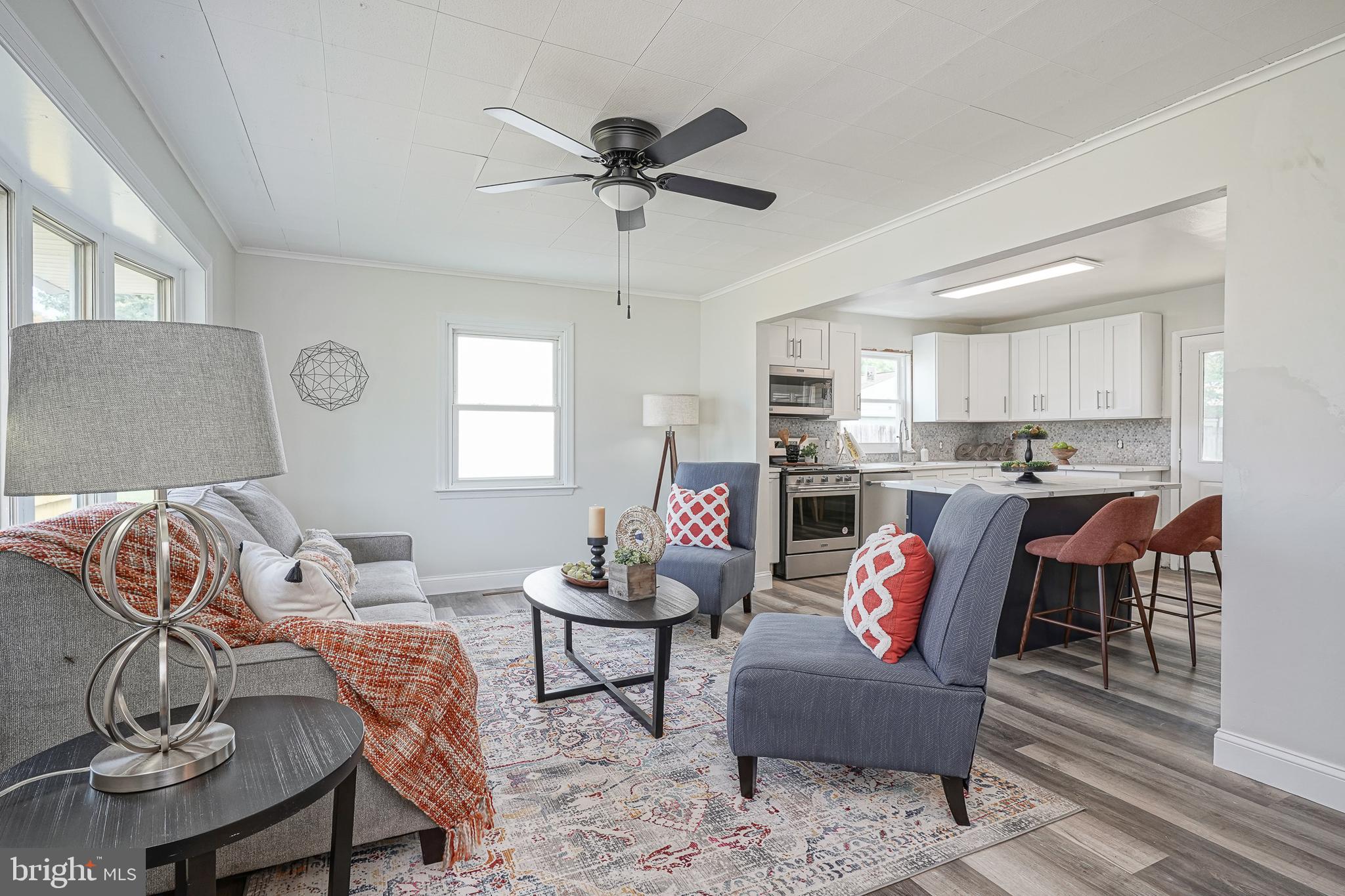 a living room with furniture and kitchen view