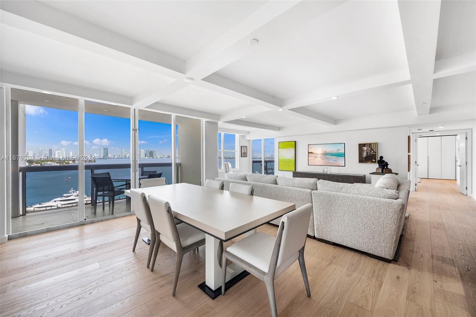 a living room with furniture a table and kitchen view