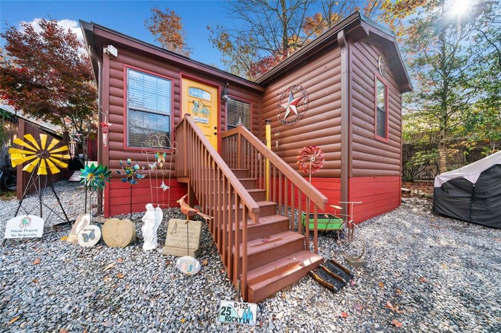 a view of a house with a yard and a deck