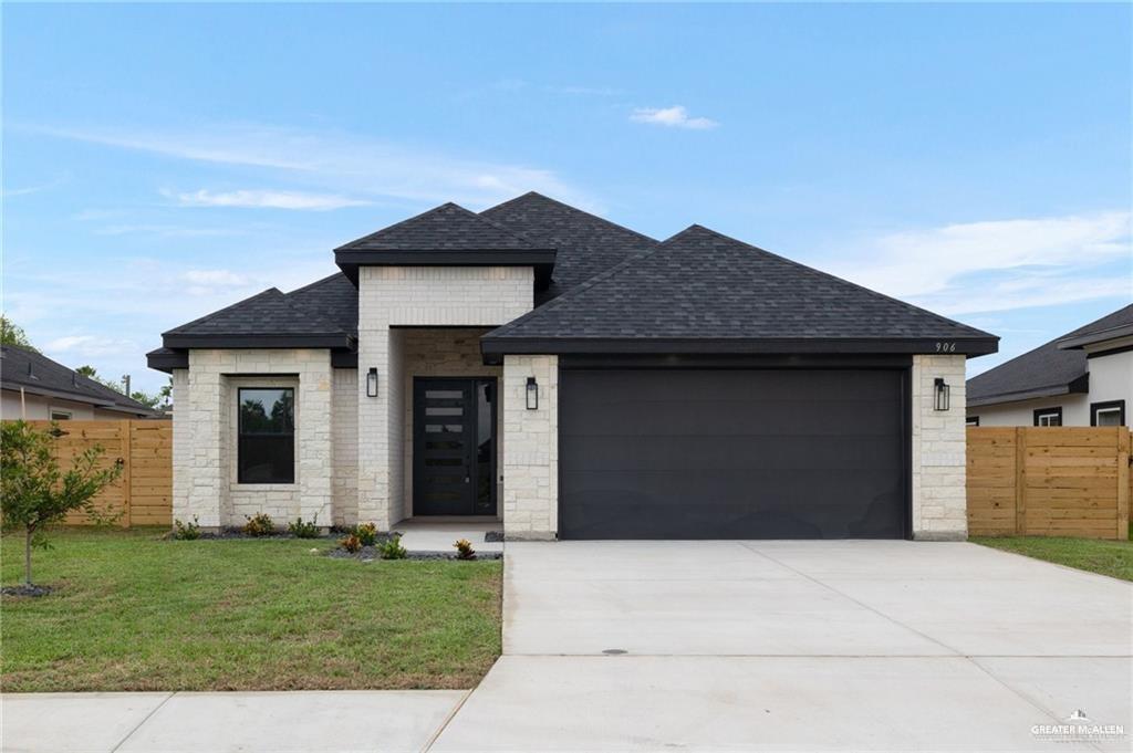 a house that has a lot of windows and yard in front of it