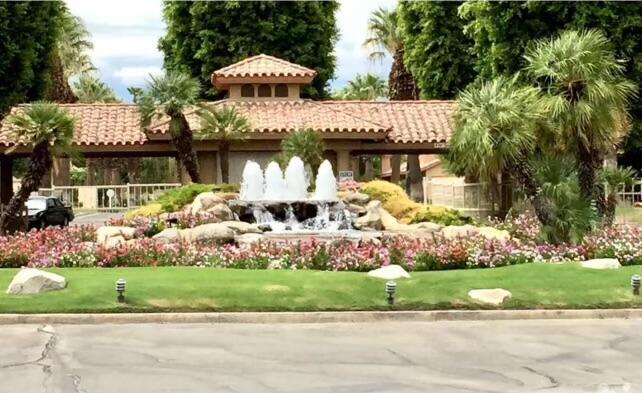 a front view of a house with a garden and plants