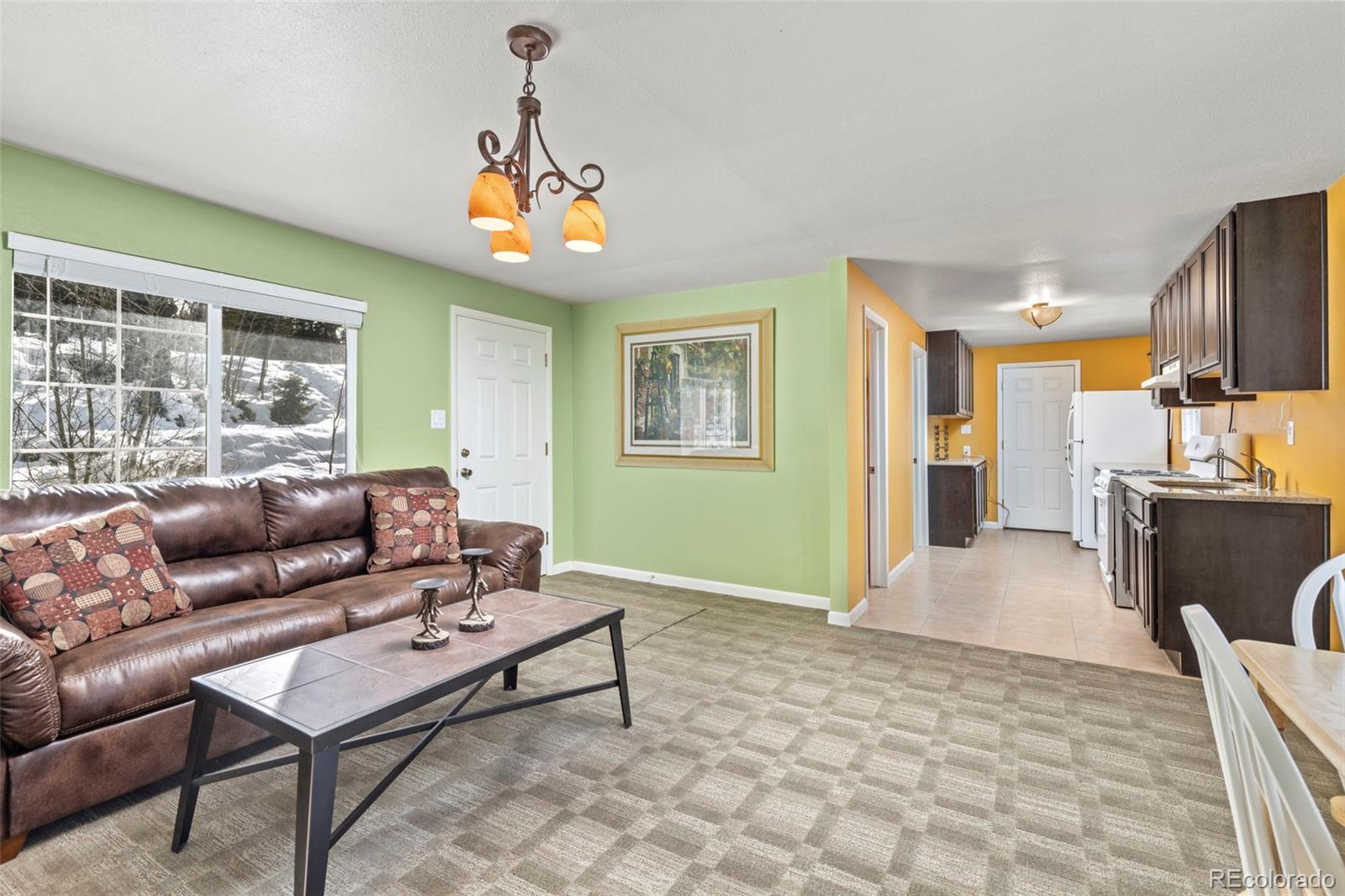 a living room with furniture and a chandelier