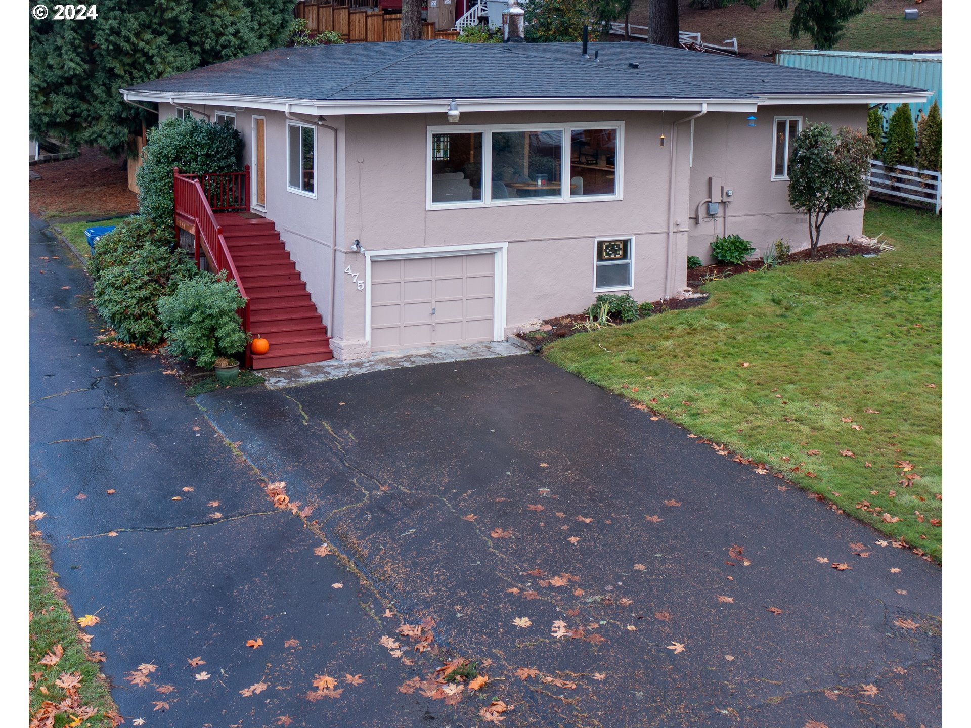 a front view of a house with a yard and a garage