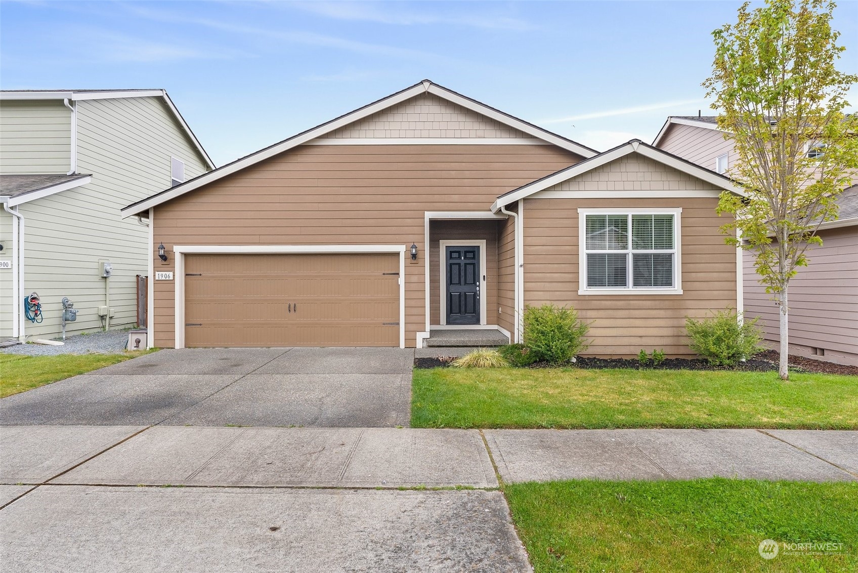 a front view of a house with a yard and garage