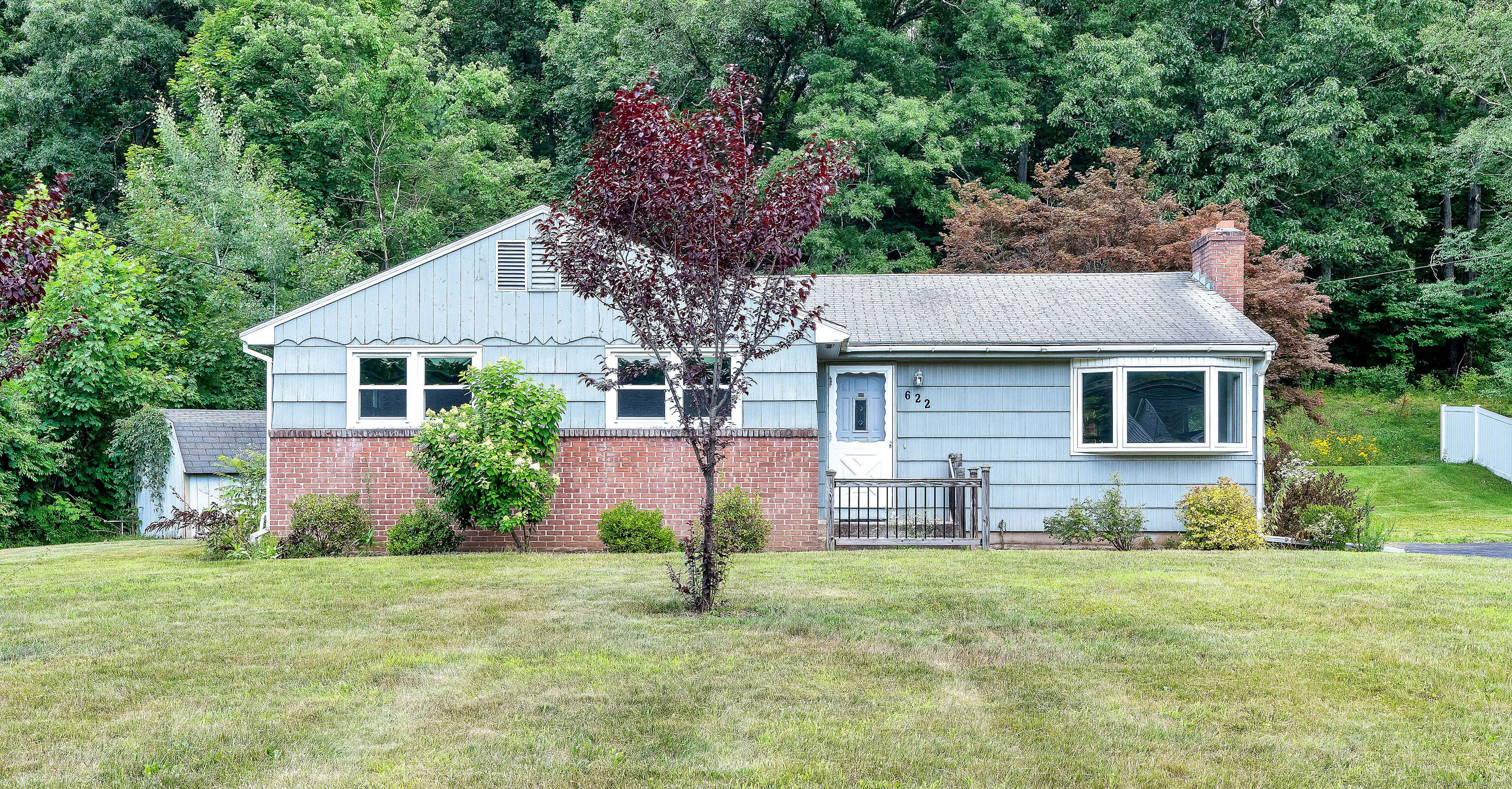 a aerial view of a house with a yard and potted plants