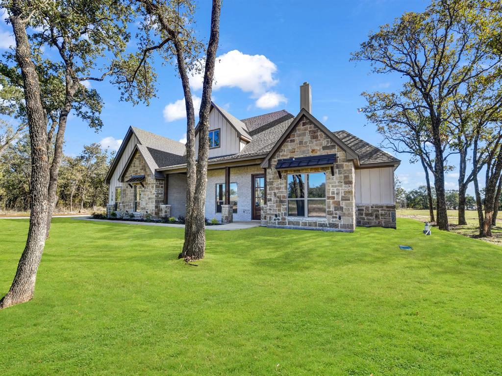 a front view of a house with garden