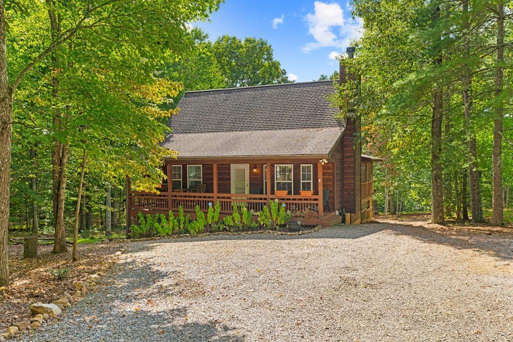 a view of house with a yard