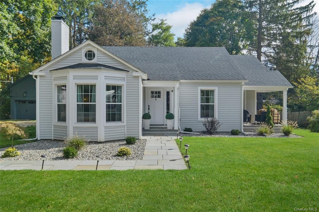 a front view of a house with a yard and porch