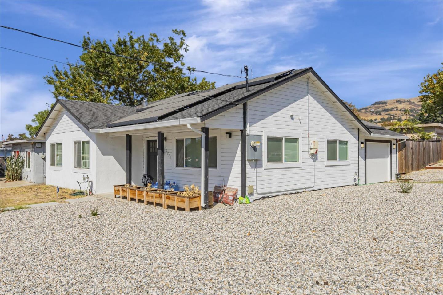 a front view of a house with a garden