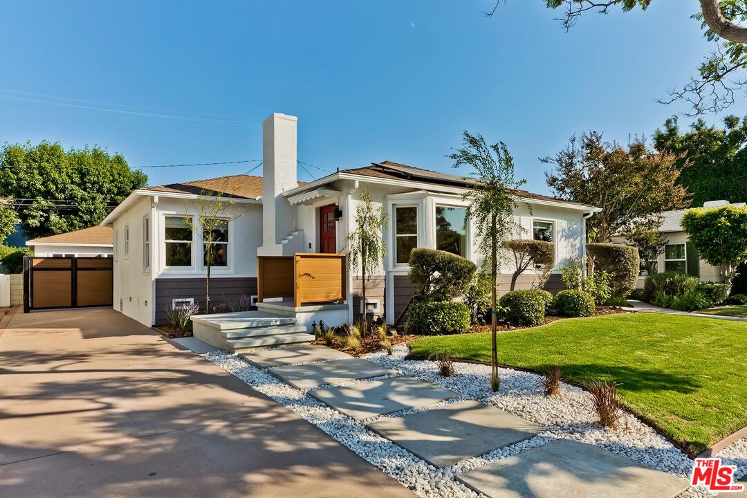 a front view of a house with a garden