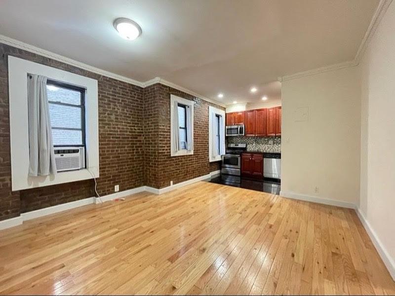 a view of a livingroom with a furniture wooden floor and window