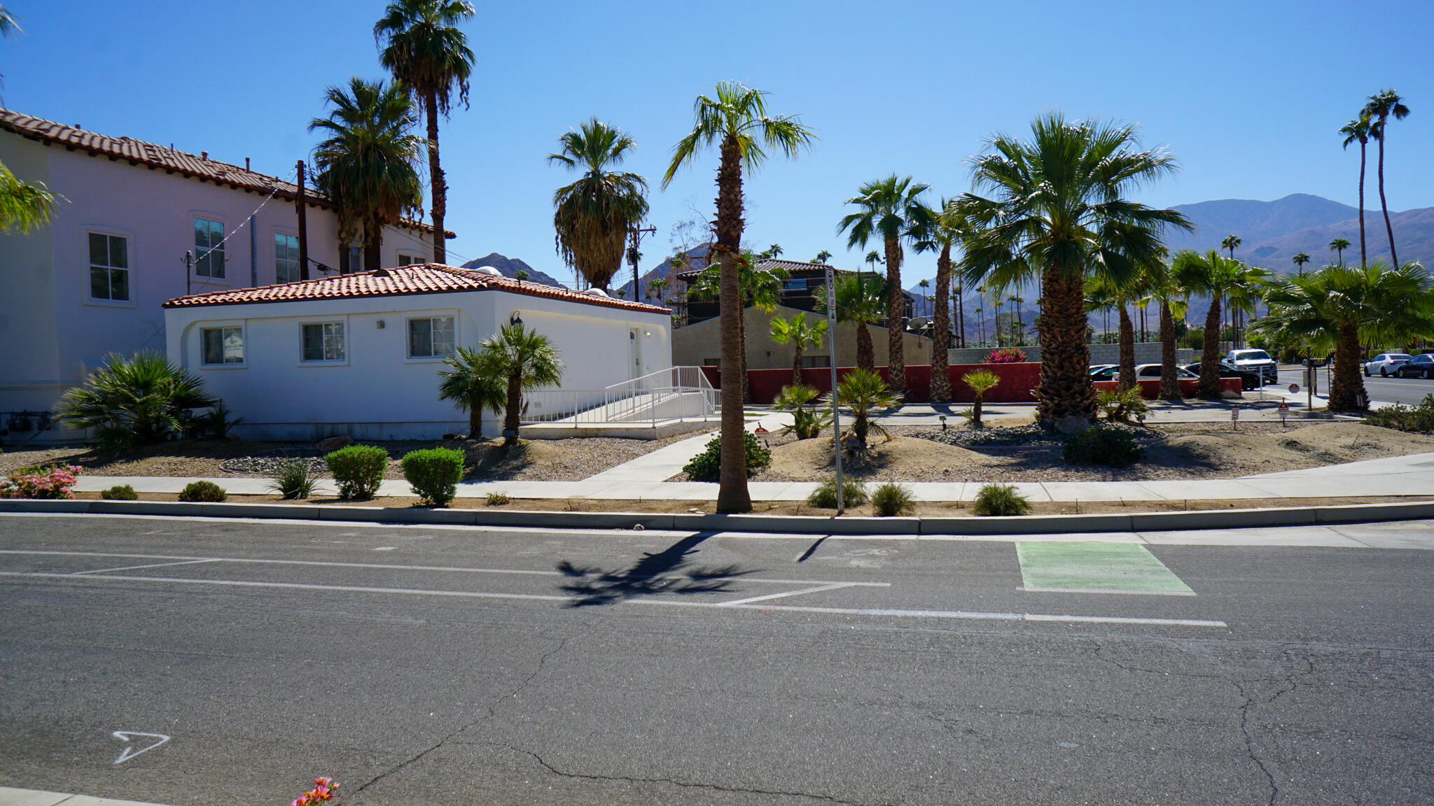 a front view of house with yard and potted plants