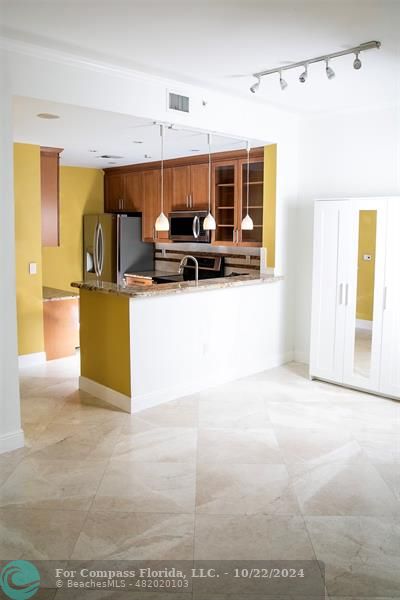 a view of kitchen with furniture and large window