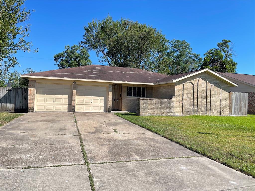 a front view of a house with a yard and a garage