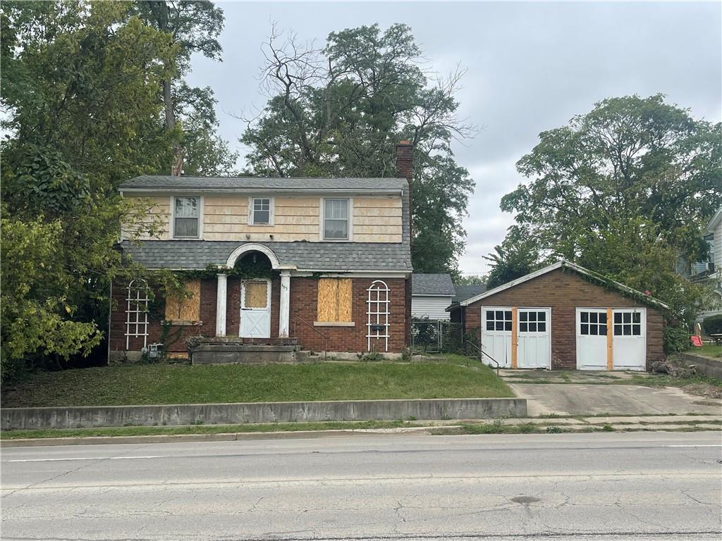 a front view of a house with a garden