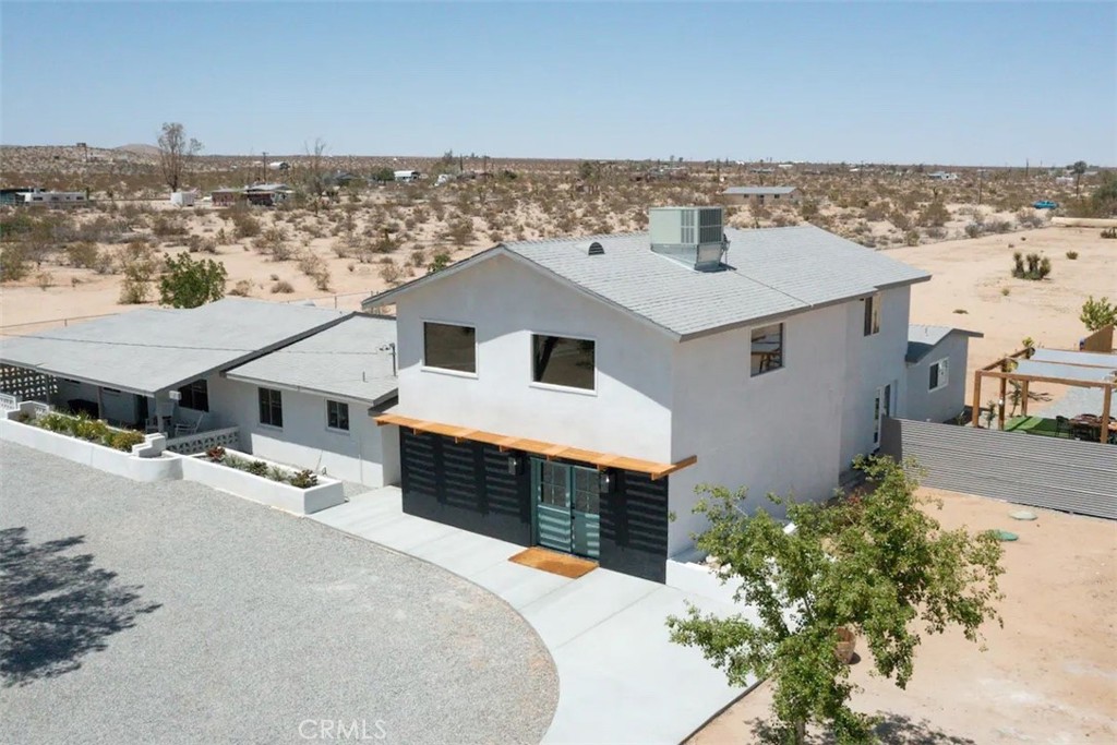 an aerial view of a house with a yard