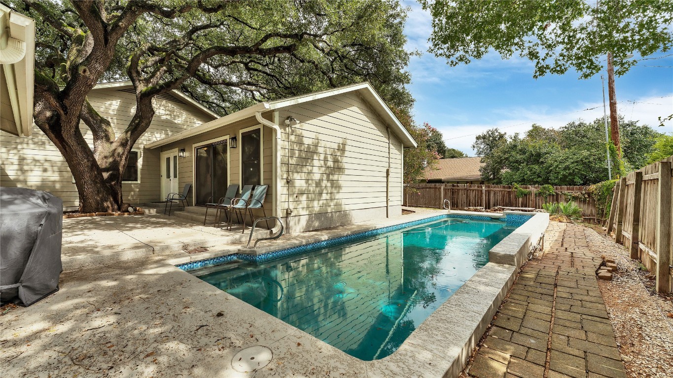 a view of a house with backyard and trees