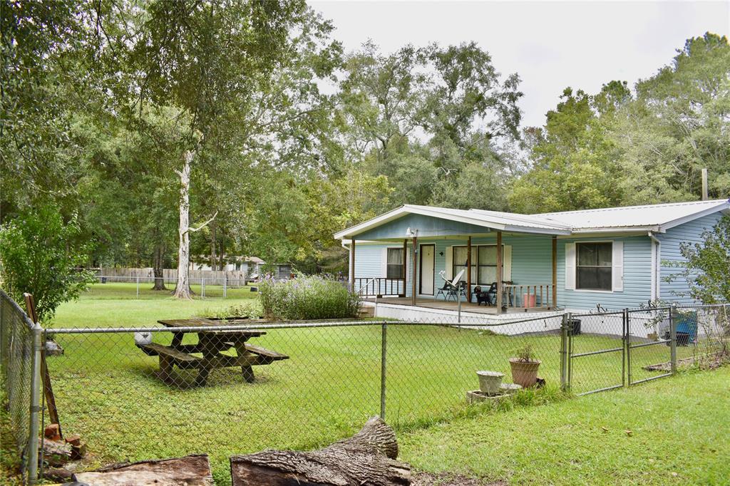 a view of a house with swimming pool and sitting area