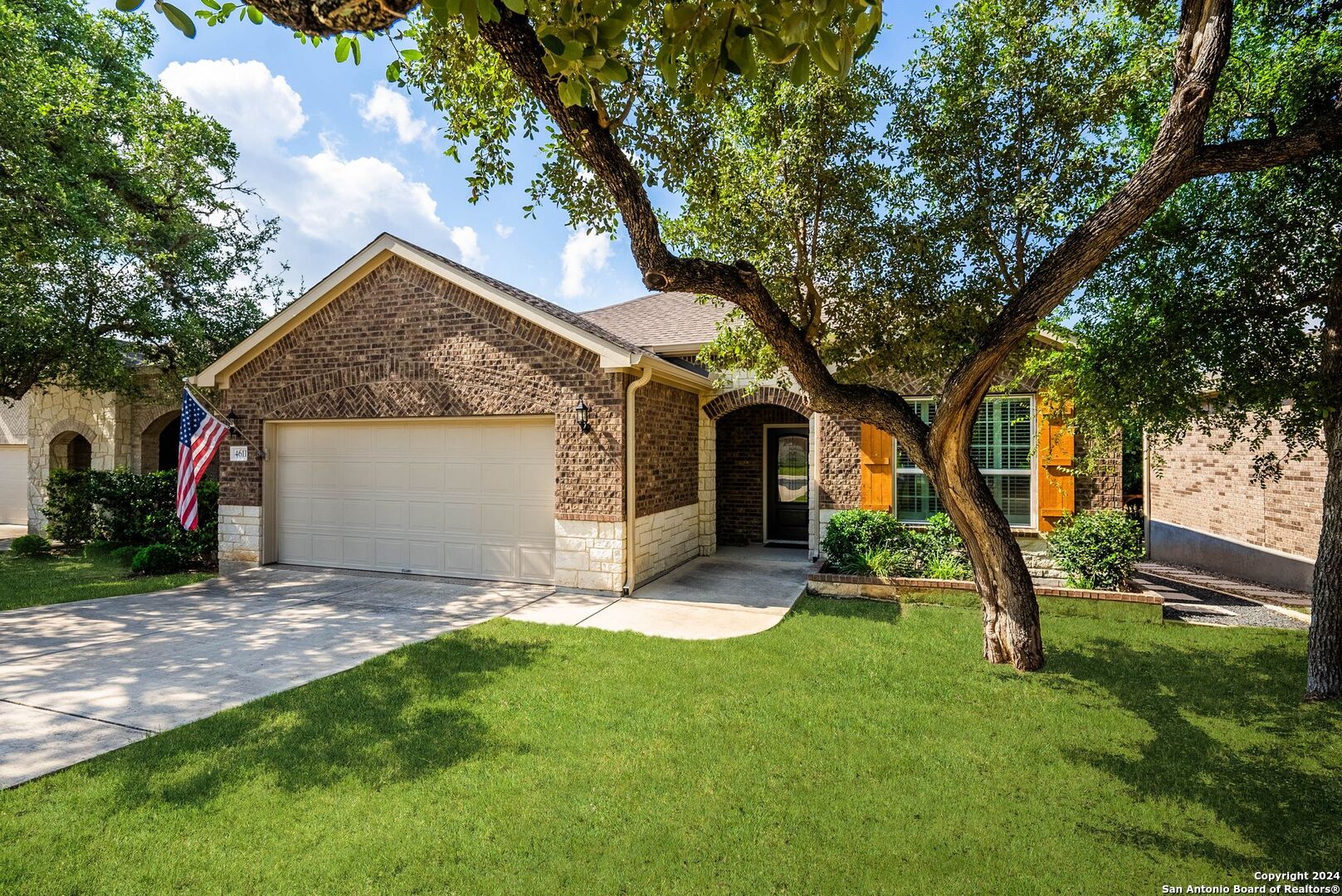 a view of a house with a yard and tree