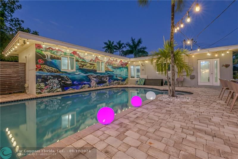 a view of a swimming pool with an outdoor space and seating area