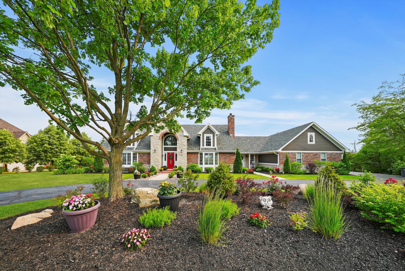 a front view of a house with a garden