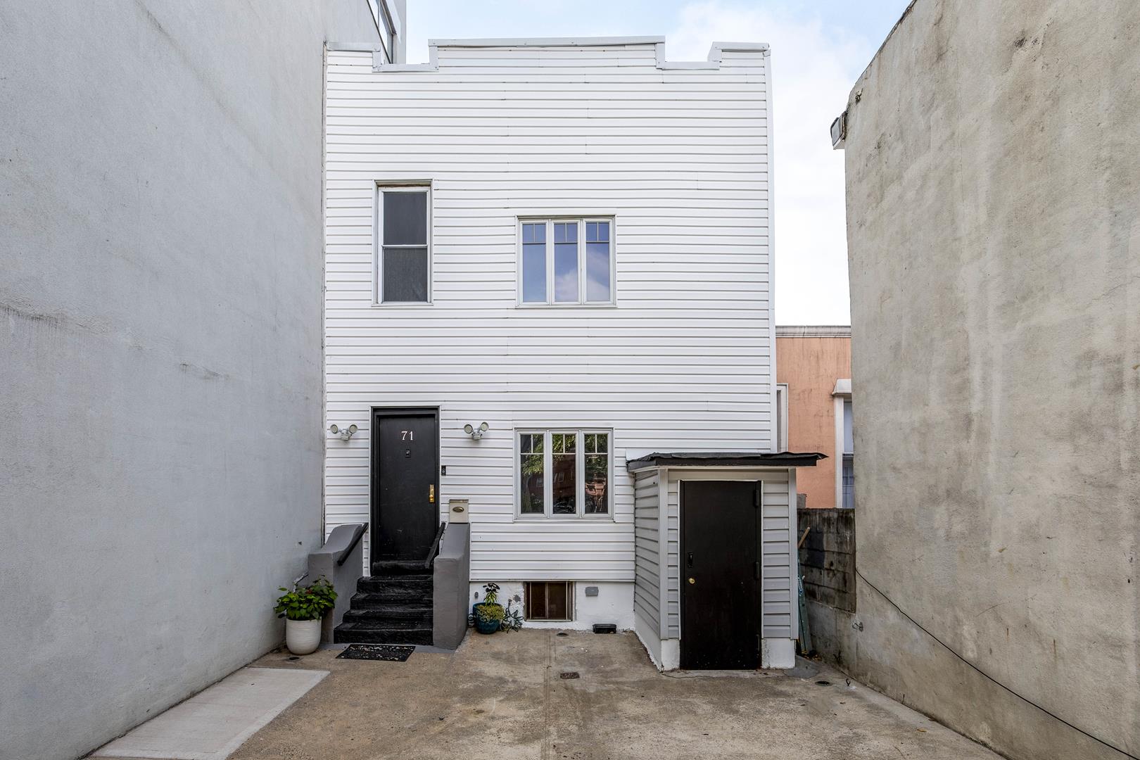 a view of a house with brick walls