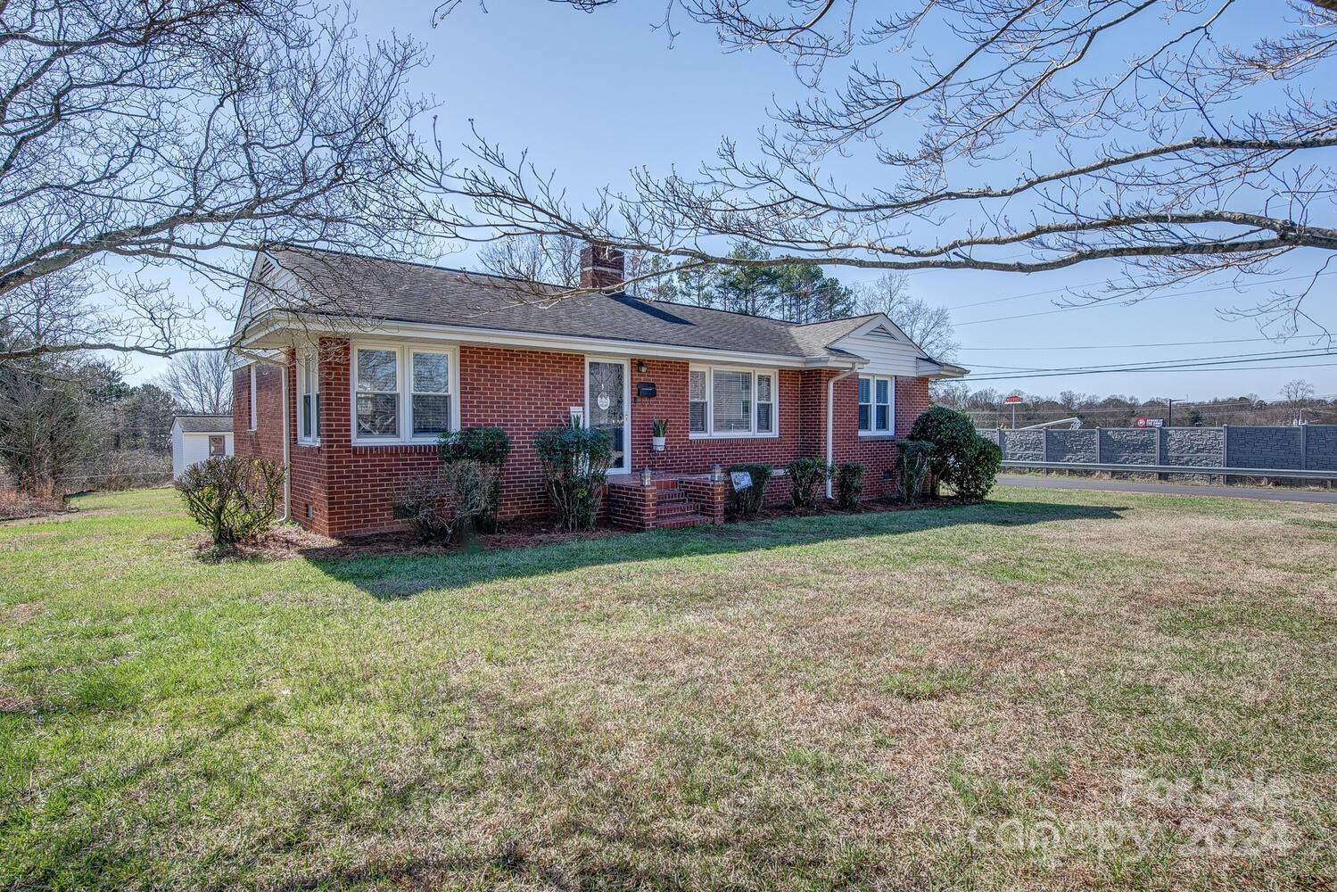 a front view of house with yard and outdoor seating