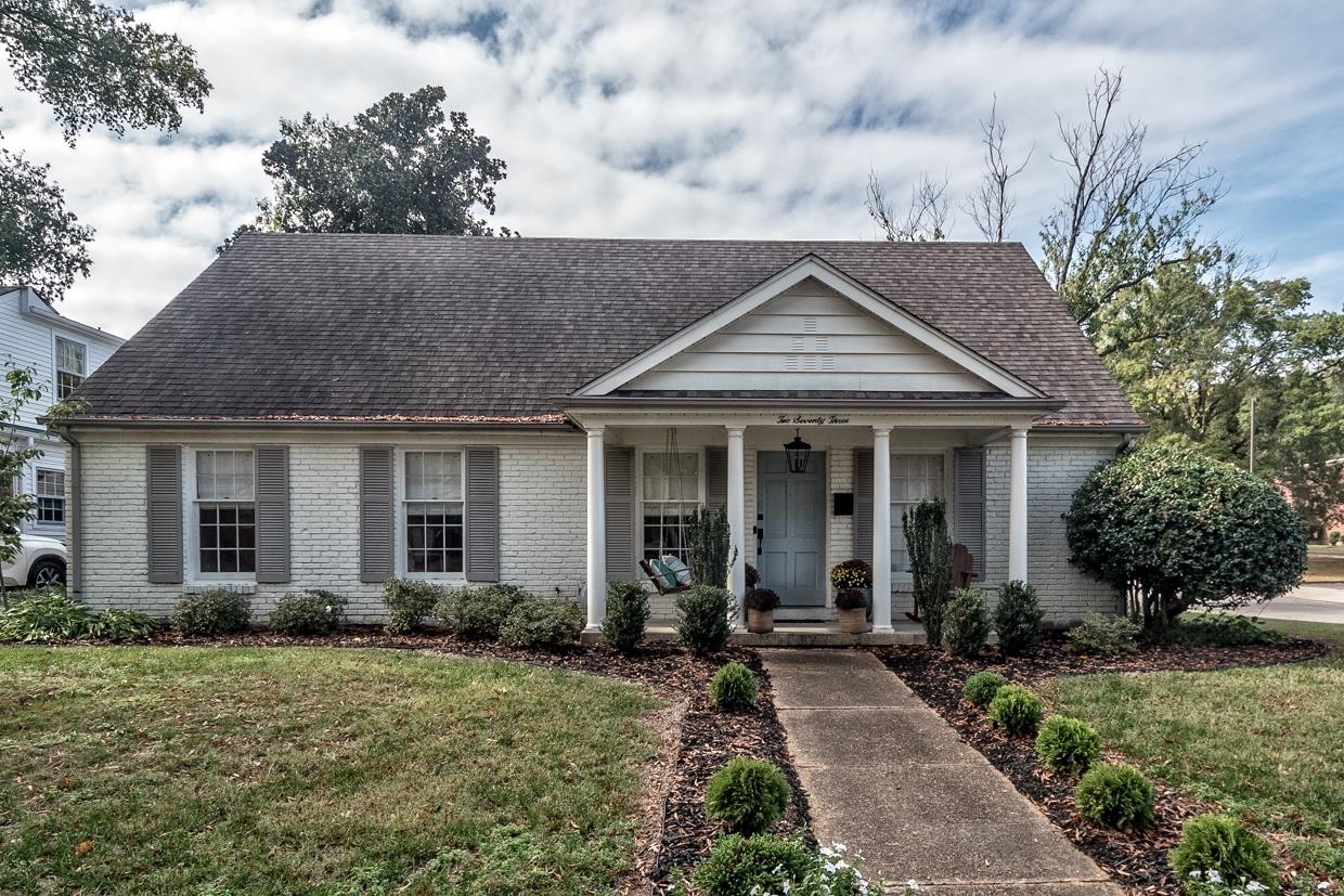 a front view of a house with garden