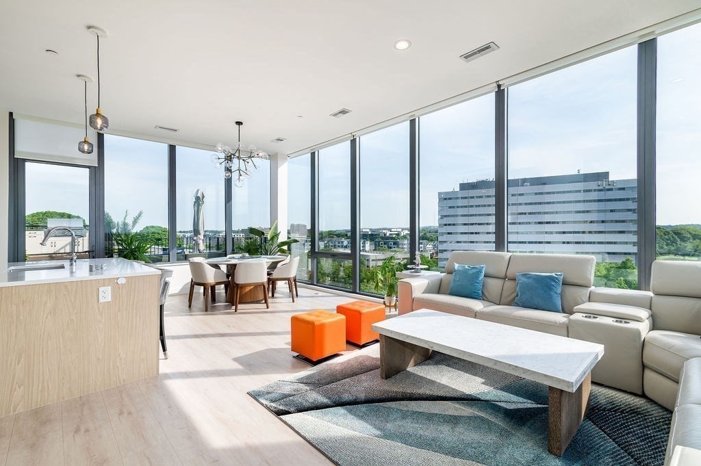 a living room with furniture and a floor to ceiling window