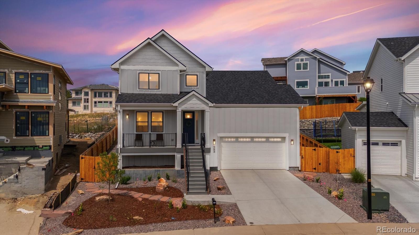 a view of a house with a garage and balcony