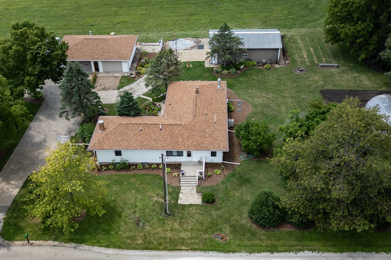 an aerial view of a house with a yard