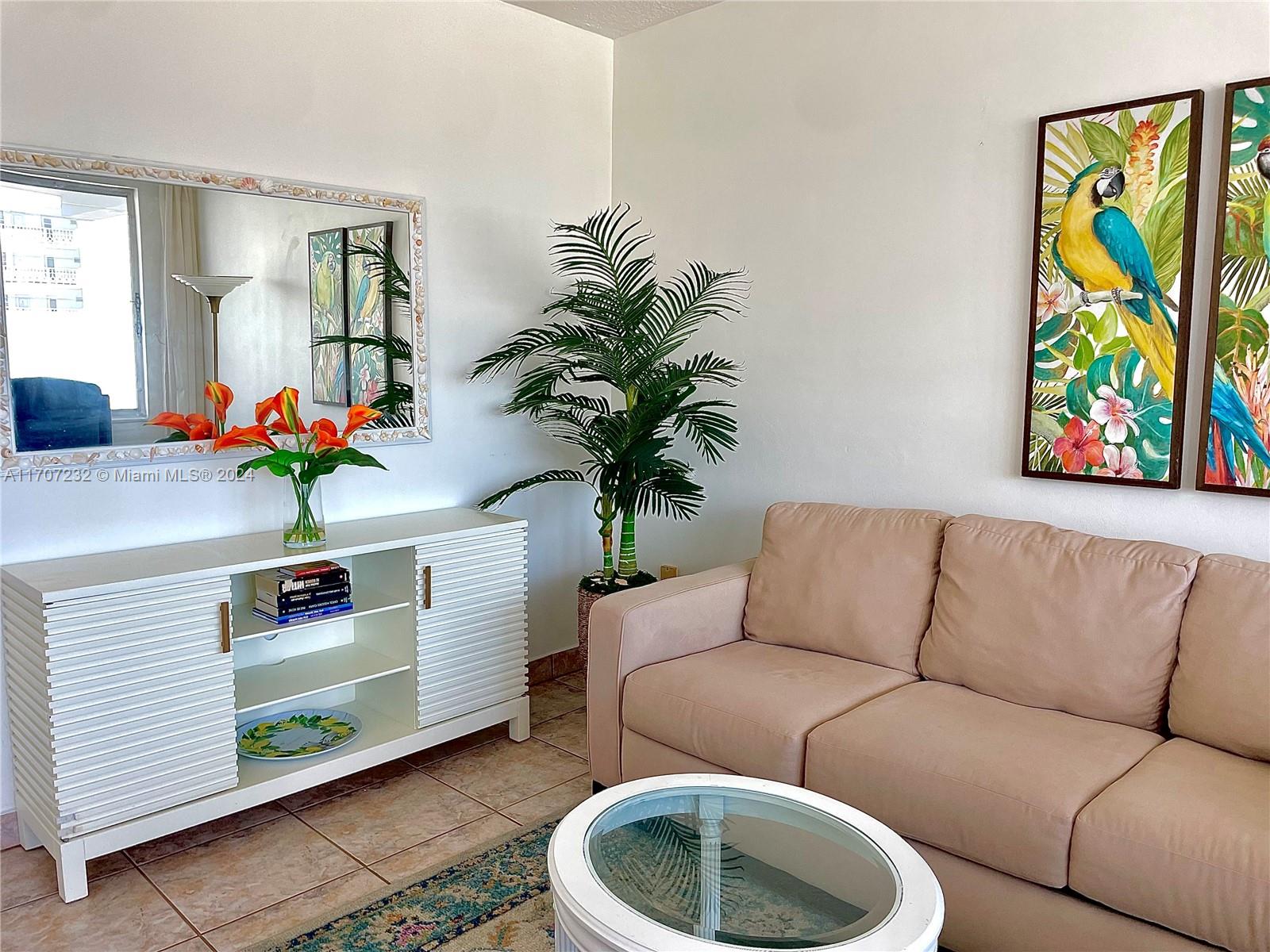 a living room with furniture and a potted plant