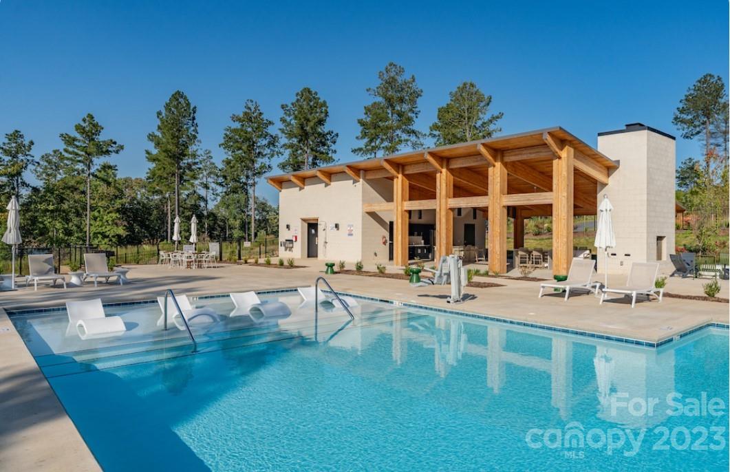 a view of a swimming pool with outdoor seating