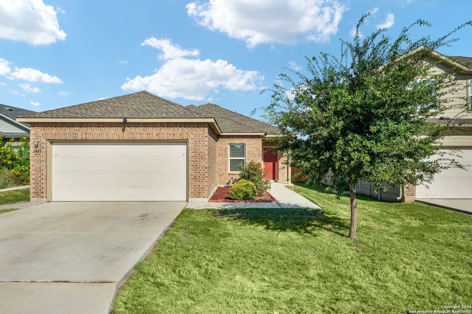 a front view of a house with a yard and garage