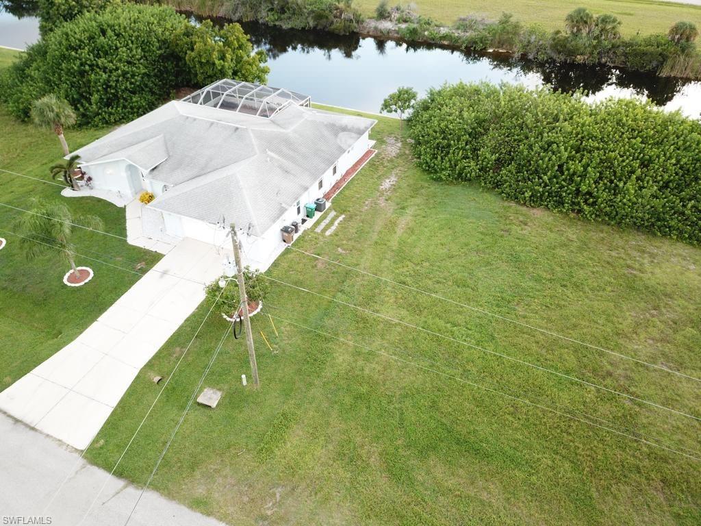 a view of a swimming pool with a yard and lake view