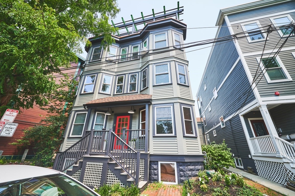 a front view of a residential apartment building with a yard