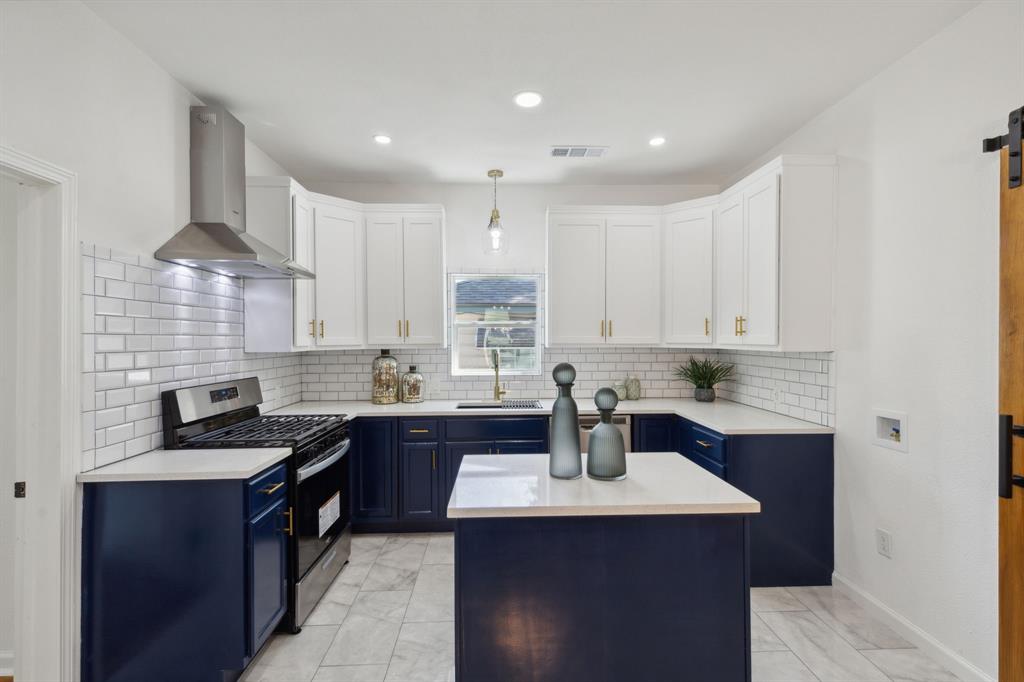 a kitchen with a sink stove and cabinets