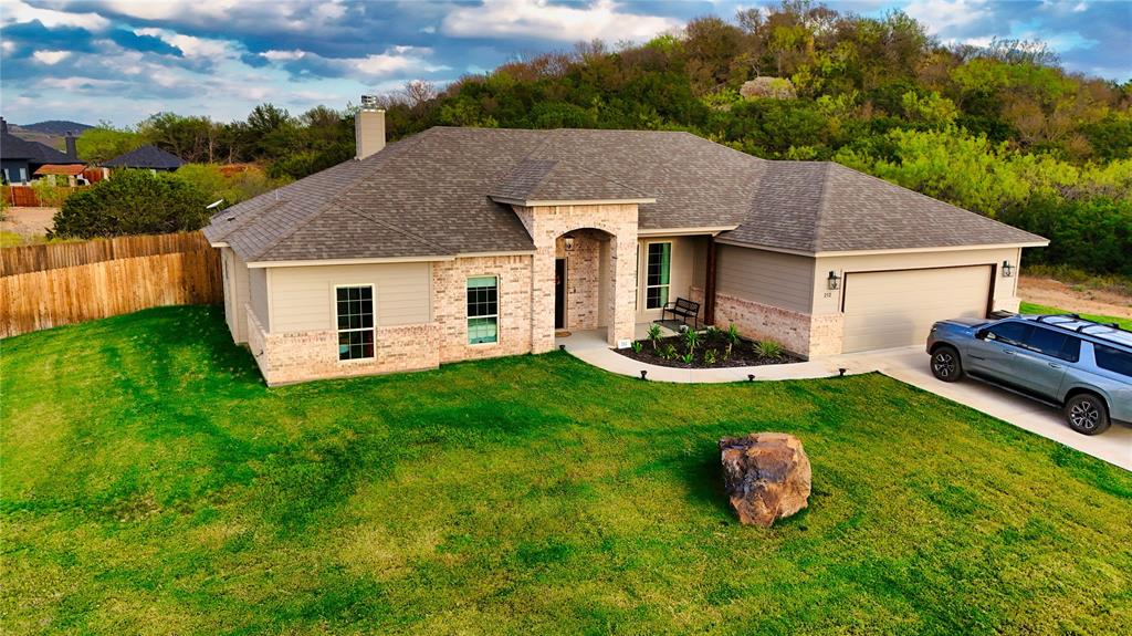 a aerial view of a house with backyard and garden