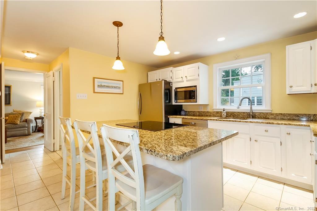 a kitchen with granite countertop sink and cabinets