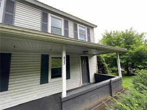 a view of a house with a window and wooden fence